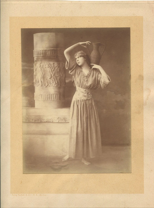 WOMAN W/VASE. TONED SILVER PRINT 8X6 ON 11X9 CARD. 1910-30.