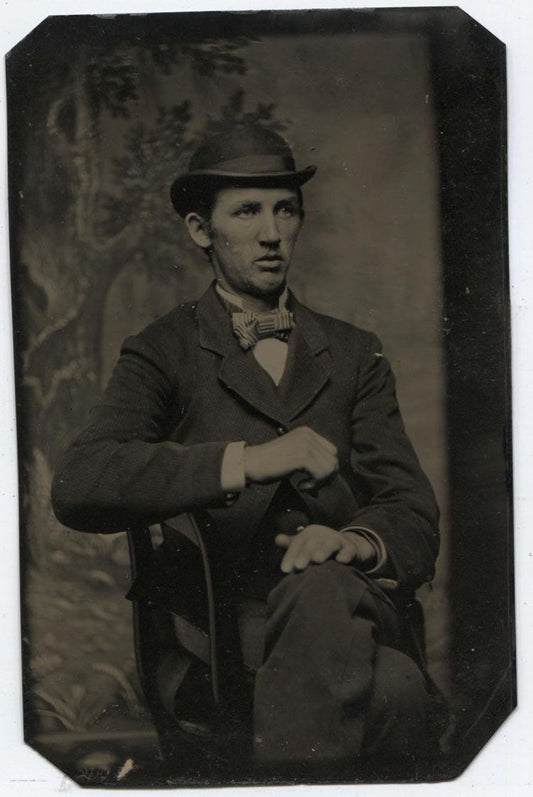 ANTIQUE TINTYPE PORTRAIT SMARTLY ATTIRED MAN IN BOWLER HAT PAINTED BACKGROUND.