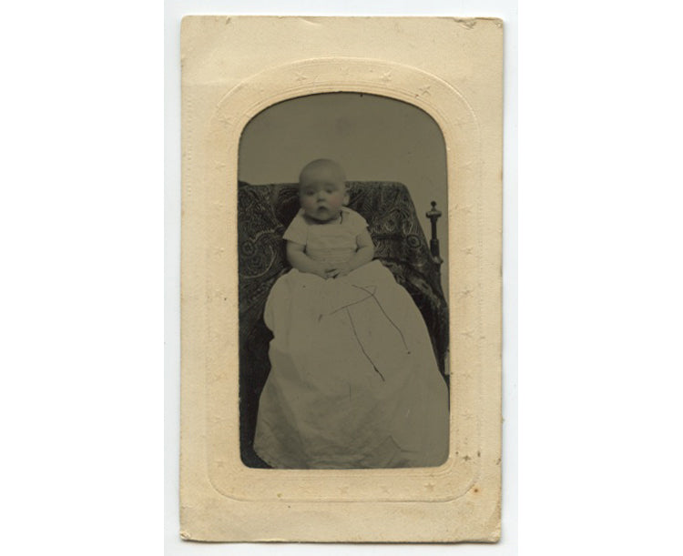 TINTYPE STUDIO PORTRAIT OF BABY IN LONG DRESS W/ TINTED CHEEKS