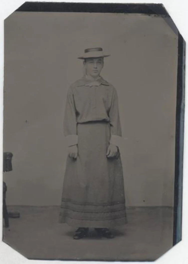 UNMOUNTED TINTYPE, YOUNG GIRL WITH SILLY HAT LOOKING UNHAPPY. TINTED CHEEKS.