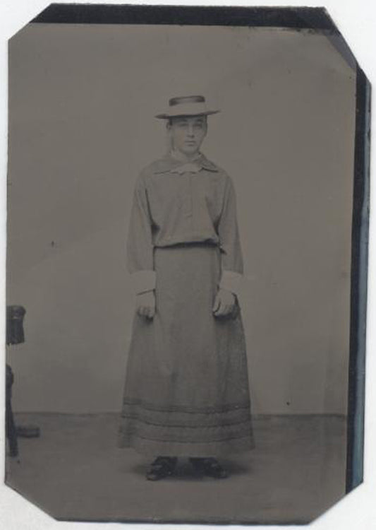 UNMOUNTED TINTYPE, YOUNG GIRL WITH SILLY HAT LOOKING UNHAPPY. TINTED CHEEKS.