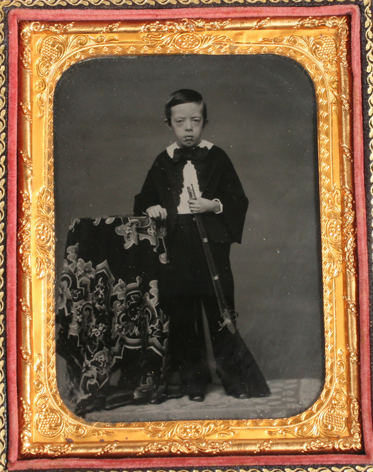 AMBROTYPE BOY WITH 1850S RIFLE. AMBER GLASS, 1/4 PLATE FULL CASE.