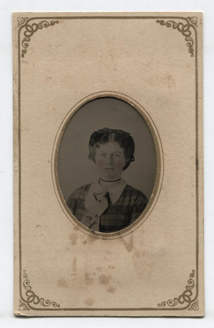 TINTYPE WOMAN WITH HAIR BOW, PLAID DRESS AND TINTED CHEEKS. PERIOD PAPER MAT.