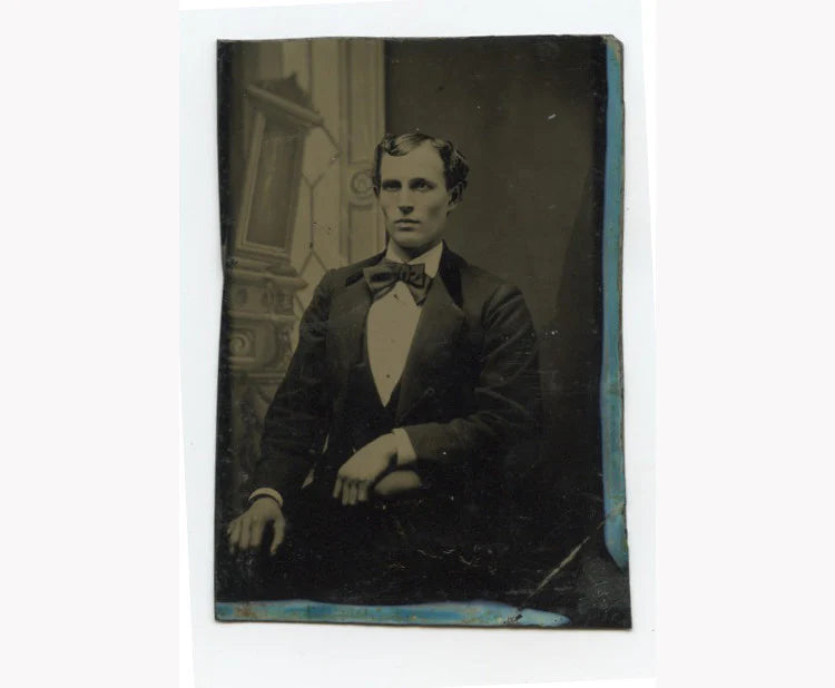 TINTYPE PORTRAIT MAN W/ BOW TIE SEATED BY PAINTED BACKGROUND, 1/6 PLATE