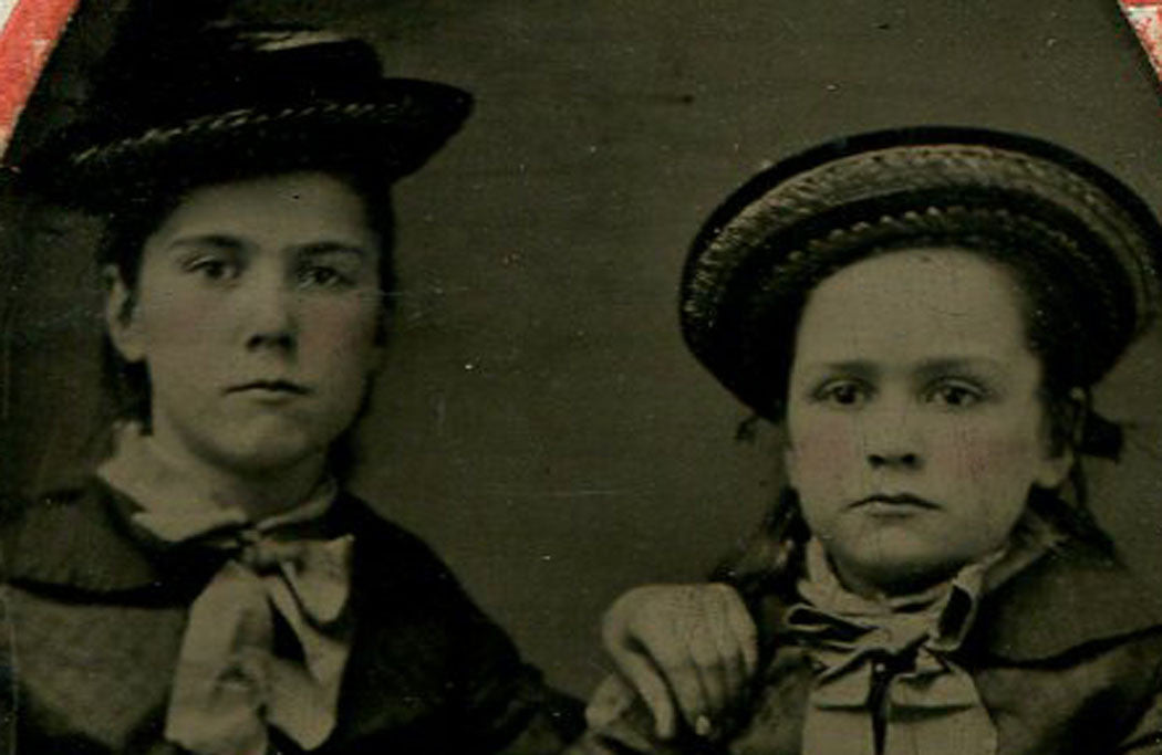 TWO YOUNG GIRLS LOOKING VERY GROWN UP. COOL HATS, BOTH. TINTED TINTYPE.