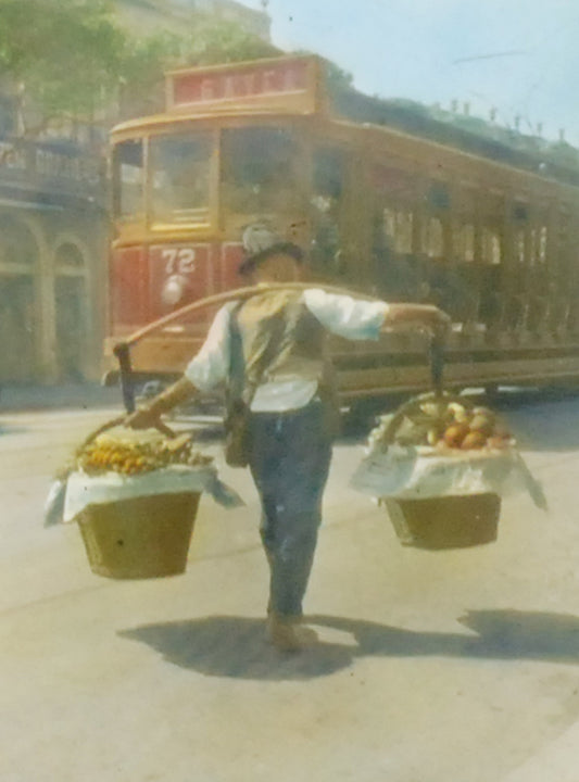 FRUIT PEDDLER WITH SHOULDER POLE, HAND TINTED ANTIQUE PHOTO ON GLASS