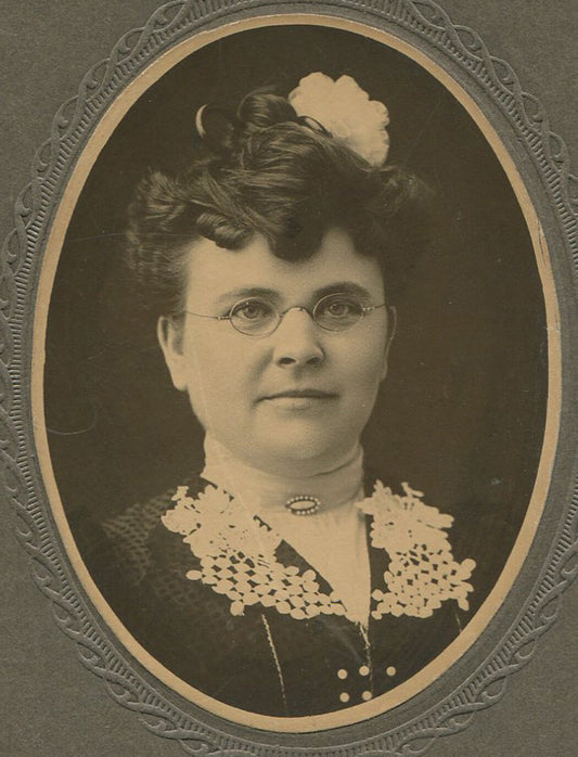 Vintage photo: round-faced woman with round glasses - oval silver print on card,