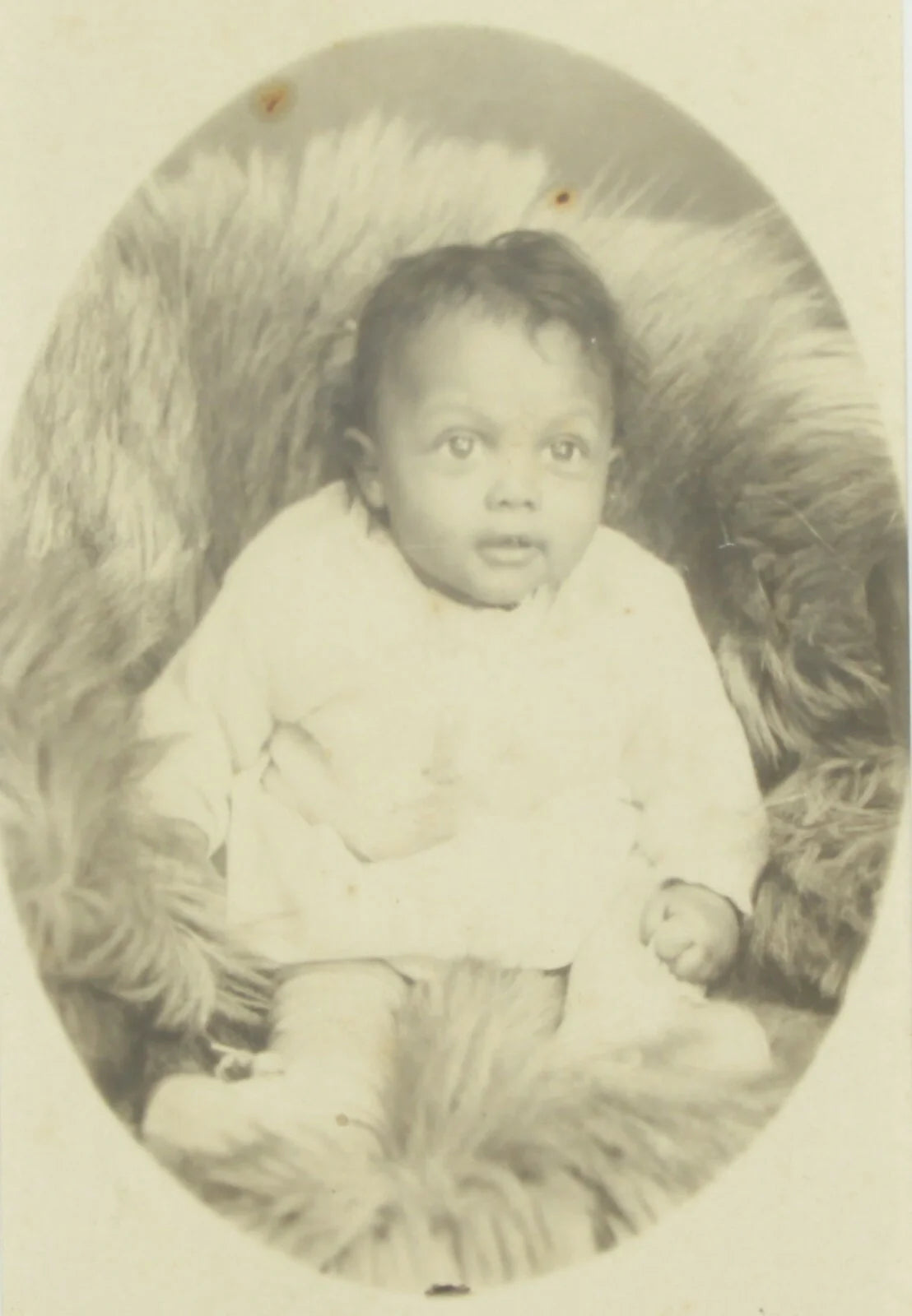 AFRICAN AMERICAN BABY POSED ON FUR BLANKET. CABINET CARD IN 5X7 FRAME.