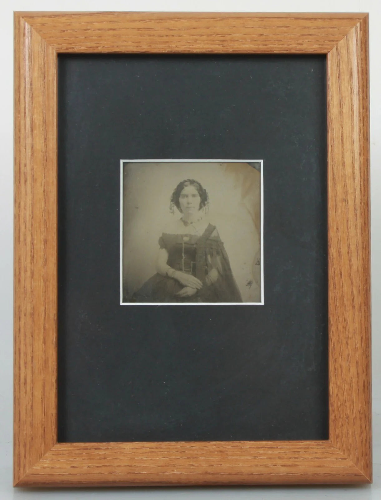 BEAUTIFUL, HAUNTING AMBROTYPE OF A WOMAN. 5X7 FRAME WITH ARCHIVAL MATTING.