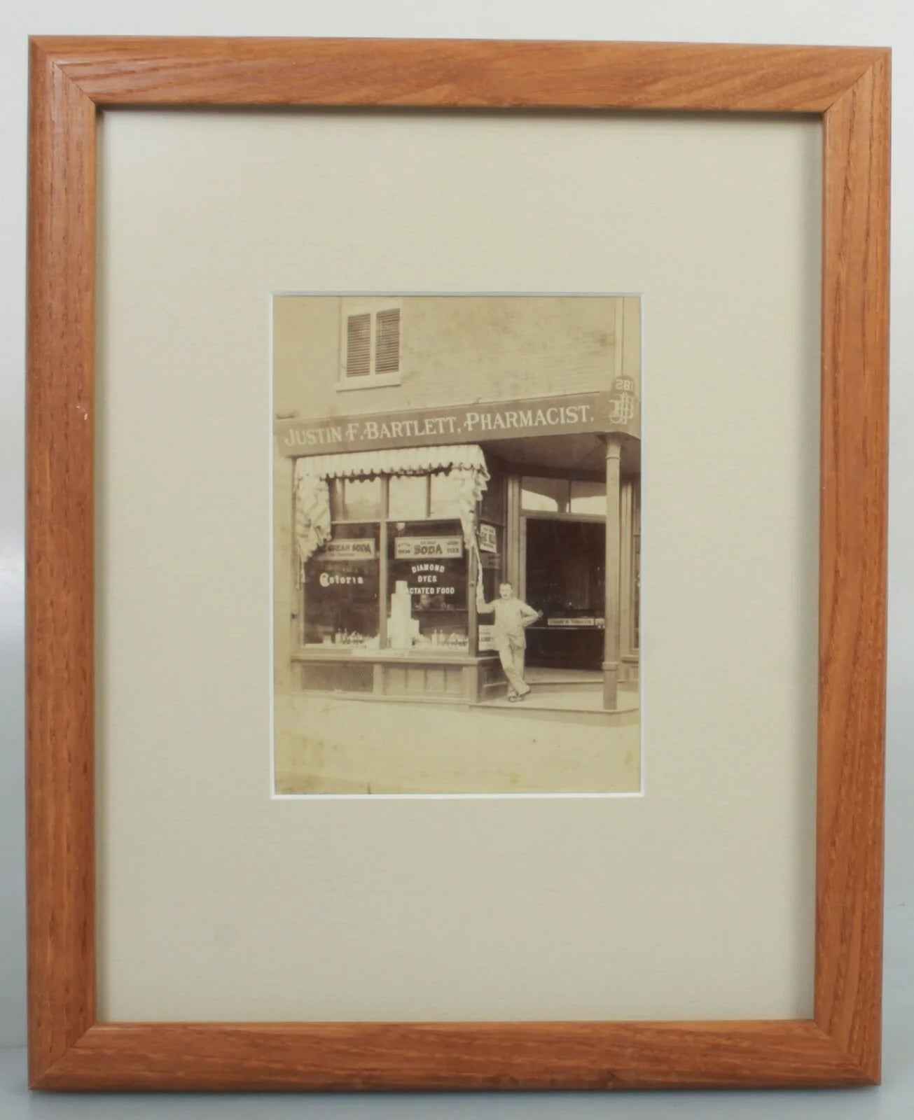 JUSTIN F. BARTLETT  PHARMACIST STORE CAB CARD IN 8X10 FRAME.