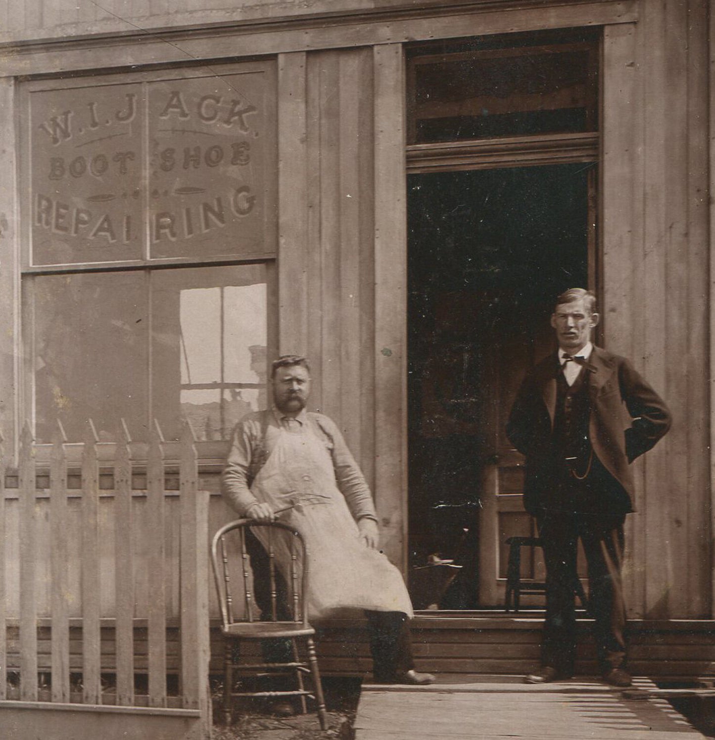 MEN STANDING OUTSIDE W.I.JACK SHOE/BOOT REPAIR SHOP. CABINET CARD.