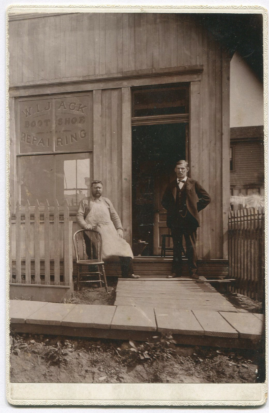 MEN STANDING OUTSIDE W.I.JACK SHOE/BOOT REPAIR SHOP. CABINET CARD.